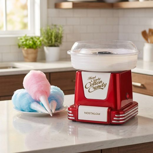Bright red retro cotton candy maker next to a plate of fluffy pink and blue candy.